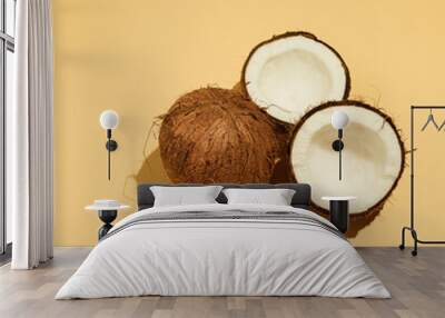 Coconut and two halves, on a yellow background, summer Wall mural