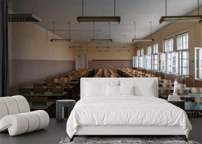 Empty old faculty or college School classroom with row of chairs, green desk tables and big white windows. Natural light. Wall mural