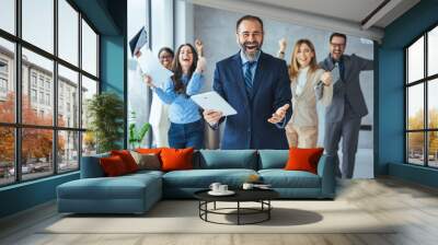 Euphoric excited business team celebrate corporate victory together in office, happy overjoyed professionals group rejoice company victory, teamwork success win triumph concept at conference table Wall mural