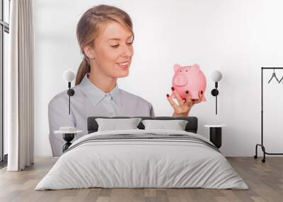 Happy business woman with her savings in a piggy bank Wall mural