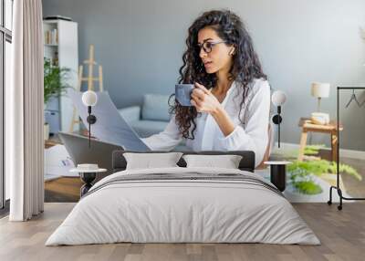 Happy Worker. Portrait of smiling girl in headphones using PC, sitting at office and listening to music, copyspace. Cheerful woman wearing wireless earphones and smiling Wall mural