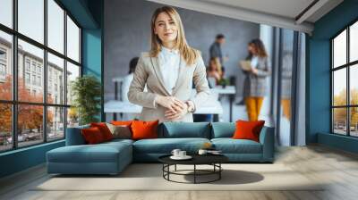 Shot of a confident young businesswoman standing in a modern office. Portrait of a businesswoman standing in the office. One Happy Pretty Business Woman Standing in office Wall mural