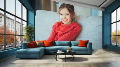 Stylish girl with pretty face at home. Little girl with long hair. Beauty and kid fashion with healthy hair. Portrait of a happy laughing child girl Wall mural