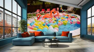 Beautifully decorated yard with pool balloons and pink flamingos. Garden decoration for a summer party Wall mural