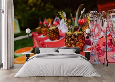 Decorated table with pineapple cocktails to celebrate a bachelorette party in a beautiful garden. The girls are having a party Wall mural