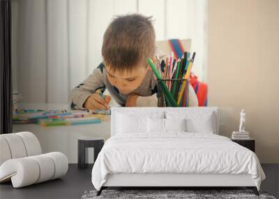 The little boy is doing homework. Wall mural