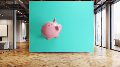 Pink ceramic piggy bank on plain cyan background. Illustration of the concept of financial investment, bank savings and economy Wall mural