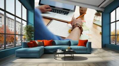 Female student working on project at home, view over the shoulder, selective focus Wall mural