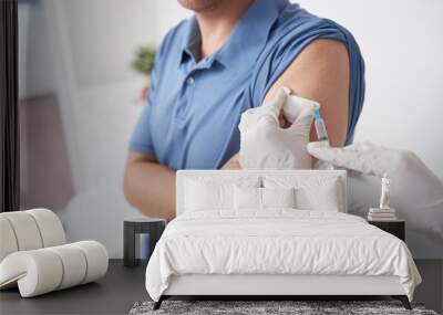 Gloved hands of doctor vaccinating patient against influenza Wall mural