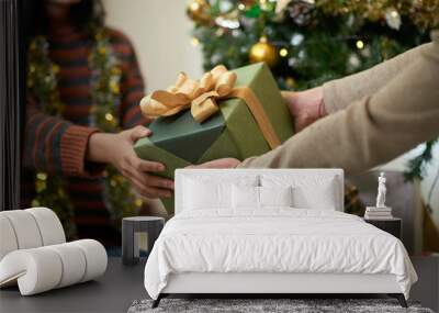 Hands of couple exchanging presents on Christmas eve Wall mural