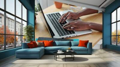 Hands of young woman typing on laptop when working at office desk at home Wall mural