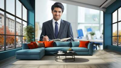 Handsome young businessman with planner Wall mural