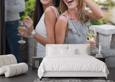 Happy laughing women drinking and dancing at party Wall mural