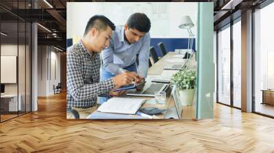 Multi-ethnic busness team working on website design at daily meeting in office Wall mural