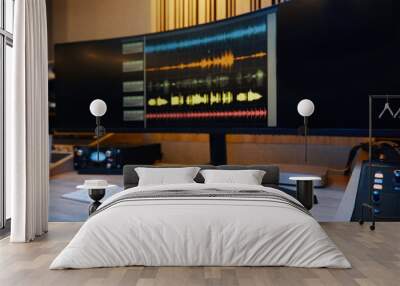 Musician sitting at table in front of monitor and making sound for song Wall mural