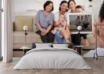 Portrait of big Asian family taking photo at home, all smiling happily on  tablet screen Wall mural