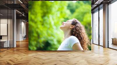 Woman breathing fresh air outdoors in summer Wall mural