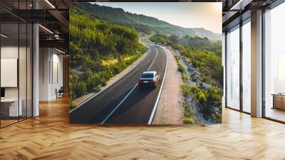 Driving on a coast road. Aerial view of a car driven on an amazing curved waving road at the Sea shore in Balchik sea resort in Bulgaria. Wall mural