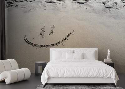 Smile on the sand.Smile face on sand.Smiley face in the sand on a beach. Wall mural