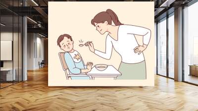 Stubborn baby refuse eating food. Mother feed ill-behaved toddler at home. Parenthood and children upbringing problems. Vector illustration.  Wall mural