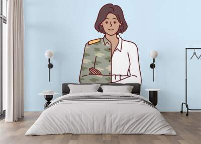 Woman is dressed in military uniform and business attire at same time, for concept of career change after serving in army. Girl manager of military company stands with arms crossed. Wall mural