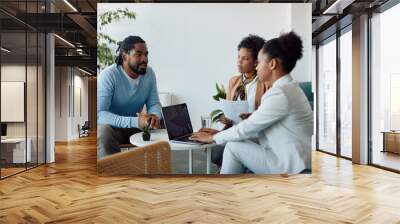 African American candidate talks to members of human resource team while having job interview in the office. Wall mural