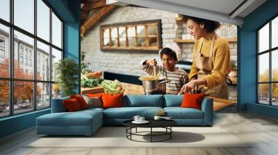 African American mother and son cooking together in the kitchen. Wall mural