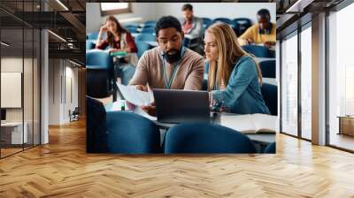 Black adult education teacher assists his student with an assignment during class in classroom. Wall mural