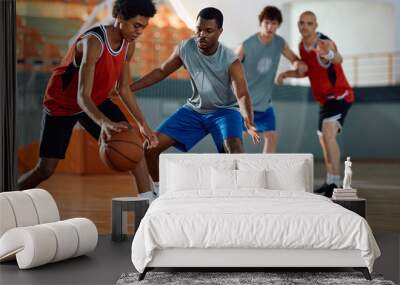 Black defense player trying to block his opponent during basketball match. Wall mural