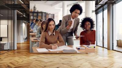 Black female professor talking to students during lecture in the classroom. Wall mural