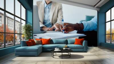 Close-up of black man signing contract with insurance agent in the office. Wall mural