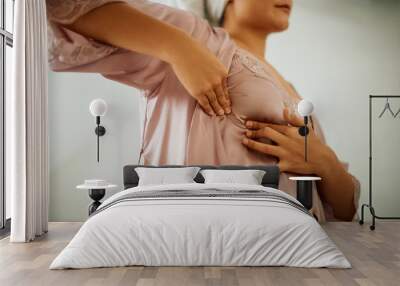 Close-up of woman doing breast self-examination at home. Wall mural