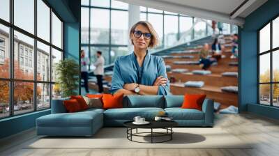 Confident businesswoman during education event at convention center looking at camera. Wall mural