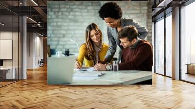 Couple analyzing their investment plans with insurance agent in the office. Wall mural