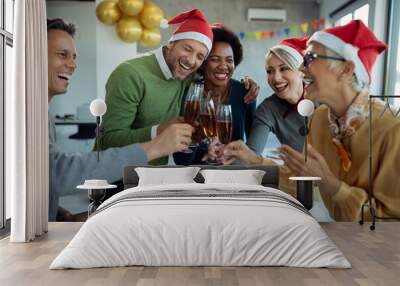 Group of happy business people toasting with Champagne on Christmas party in the office. Wall mural