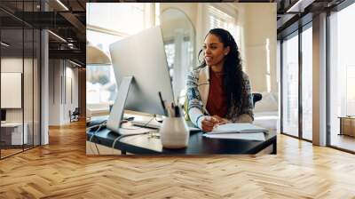 Happy African American female student having video call while e-learning at home. Wall mural