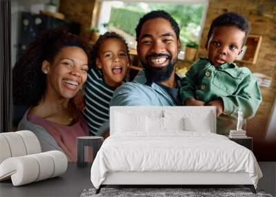 Happy black family has fun while taking selfie at home. Wall mural