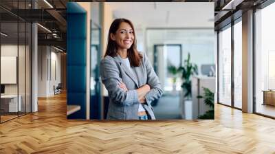 Happy confident businesswoman in office looking at camera. Wall mural