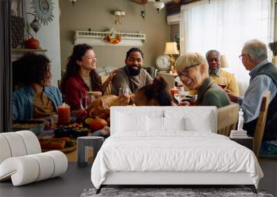 Happy multiracial extended family celebrates Thanksgiving at dining table. Wall mural