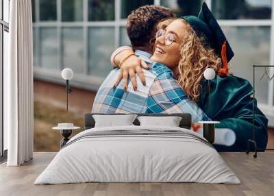 Happy student hugs her father after receiving diploma on graduation day at the university. Wall mural