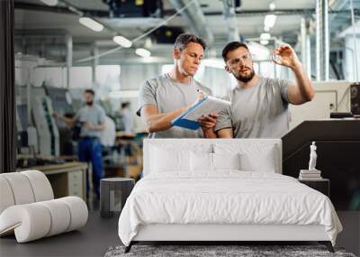 Industrial workers doing quality control of manufactured products in a factory. Wall mural