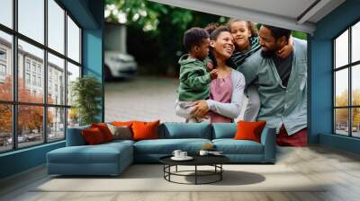 Loving black family enjoys in their time together outdoors. Wall mural