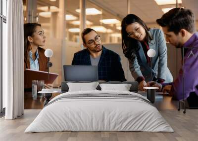 Multiracial group of business people having meeting in office. Wall mural