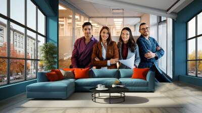 Multiracial group of happy business coworkers in office looking at camera. Wall mural