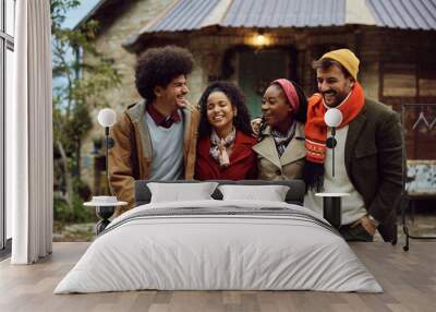 Multiracial group of happy friends talking and having fun during winter holidays. Wall mural