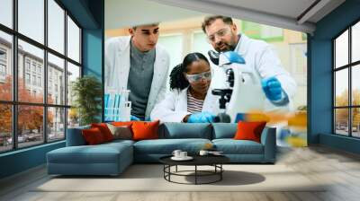 Multiracial team of scientist working on new research in laboratory. Wall mural