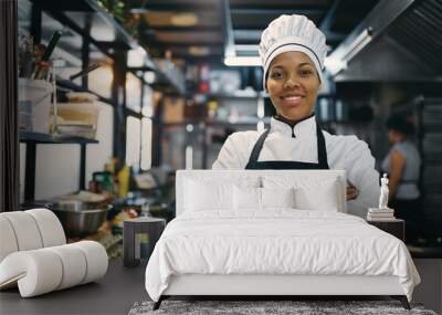 Portrait of confident black female chef at restaurant kitchen looking at camera. Wall mural