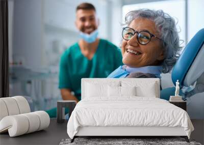 Satisfied senior woman at dentist's office looking at camera. Wall mural