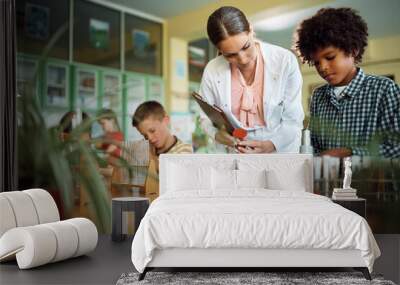 School kids having class with science teacher in classroom. Wall mural