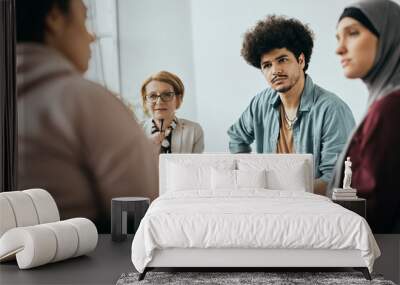 Young Muslim man and group therapy members having counseling at mental health center. Wall mural